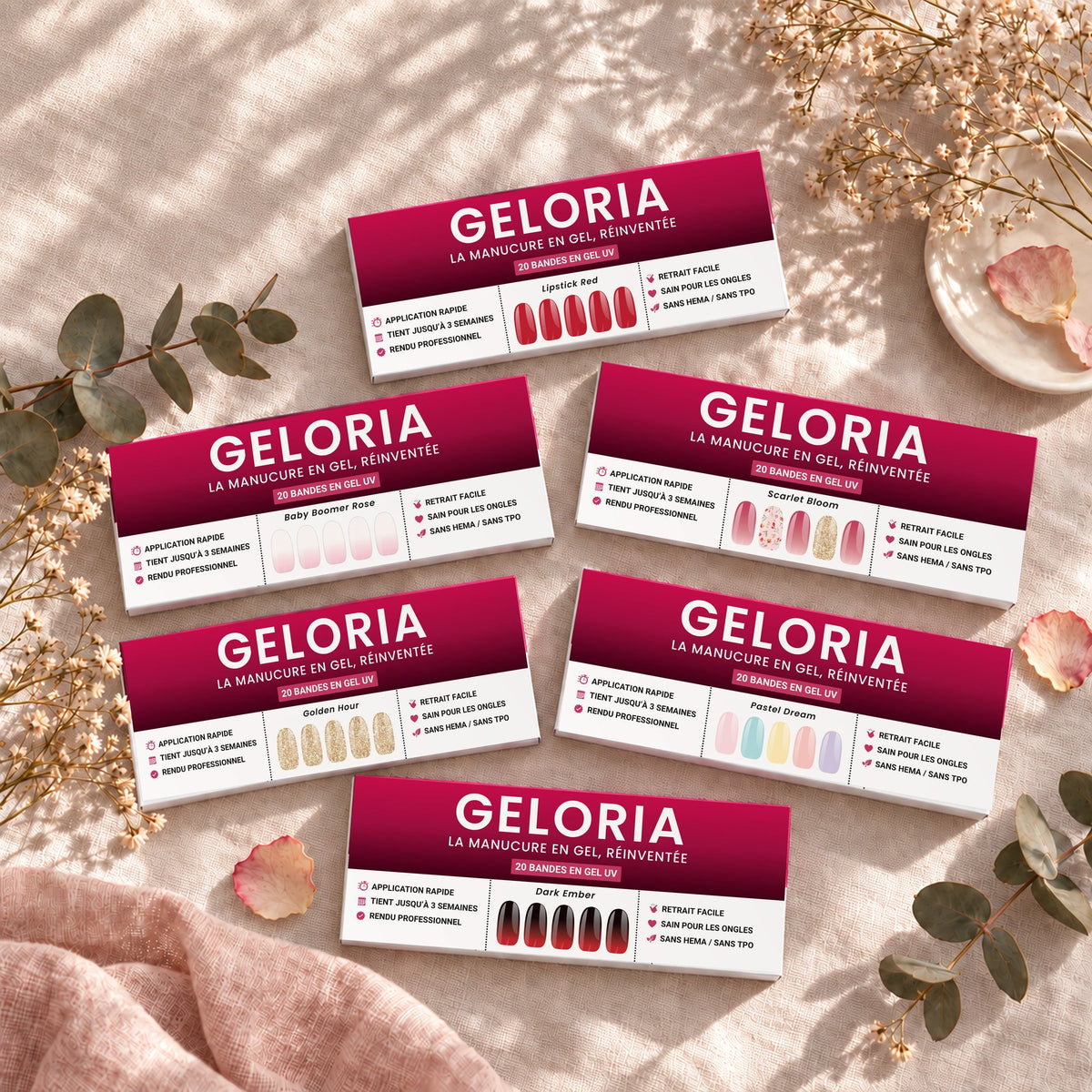 Six étuis de bandes de gel Geloria posés sur une nappe en lin avec des fleurs séchées